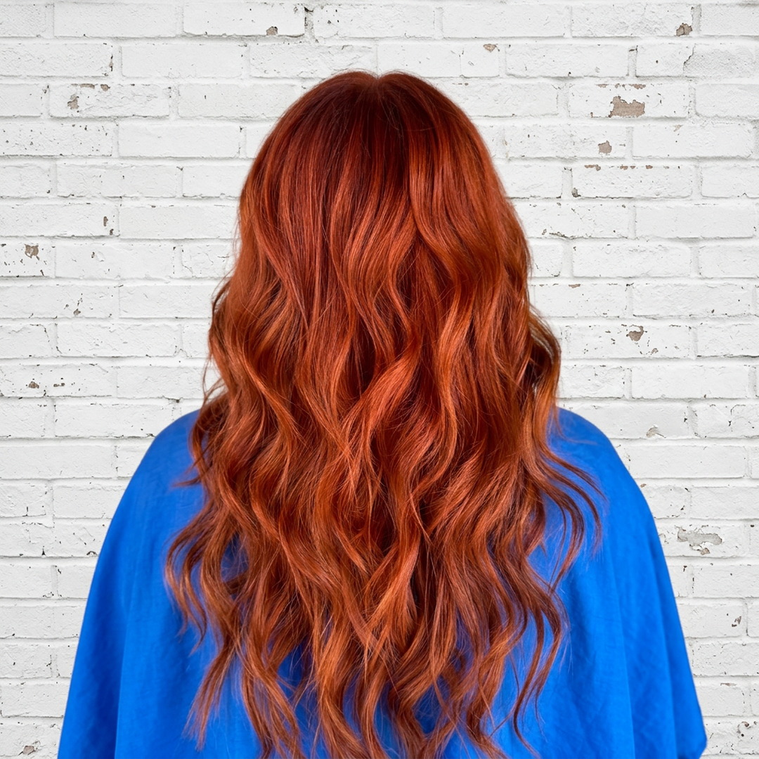 Long copper-red wavy hair color by Laila Grigley, Draper Utah hair color specialist.