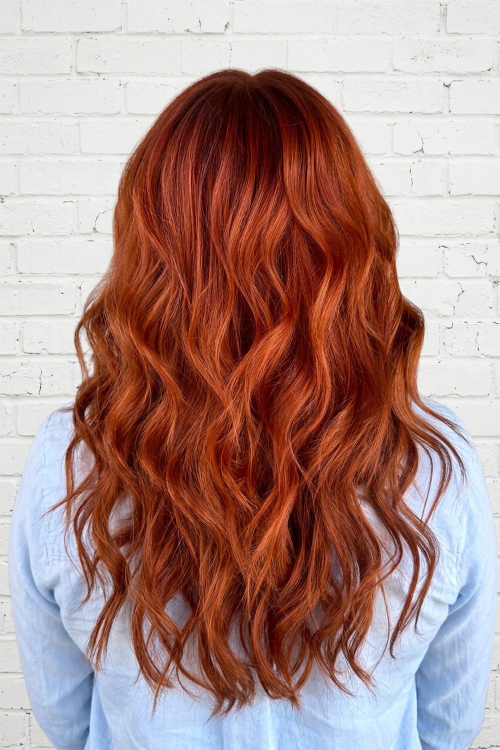 Long copper-red wavy hair color by Laila Grigley, Draper Utah hair color specialist.