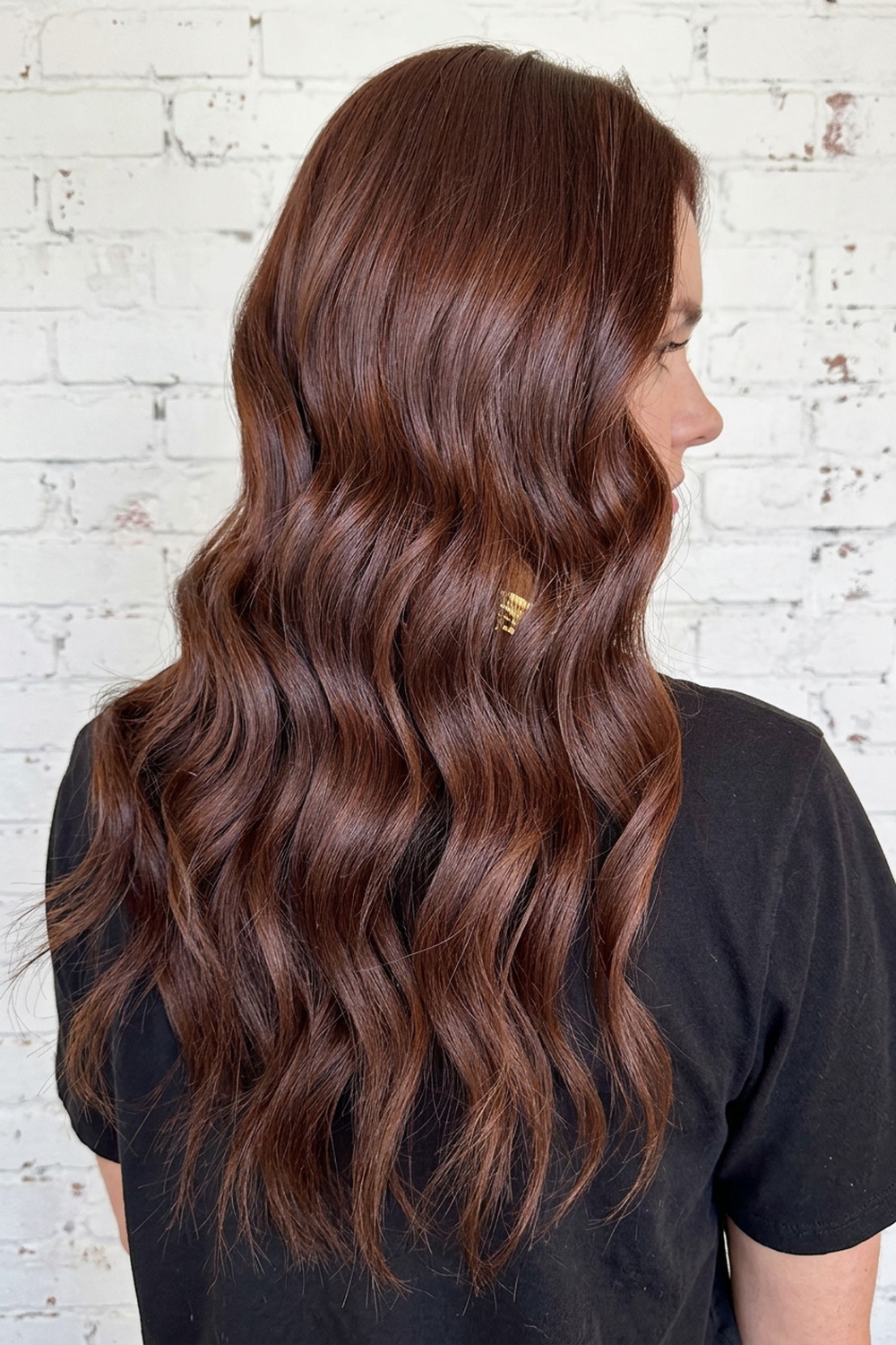 Glossy deep brunette hair color with soft waves by Laila Grigley in Draper Utah.