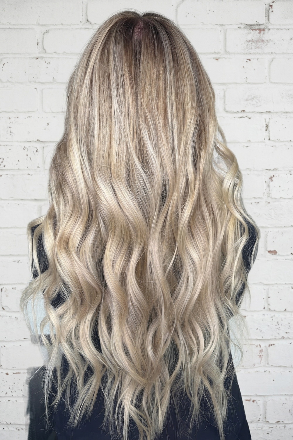 Long pale blonde waves with bright ends, blonde hair color specialist in Utah.