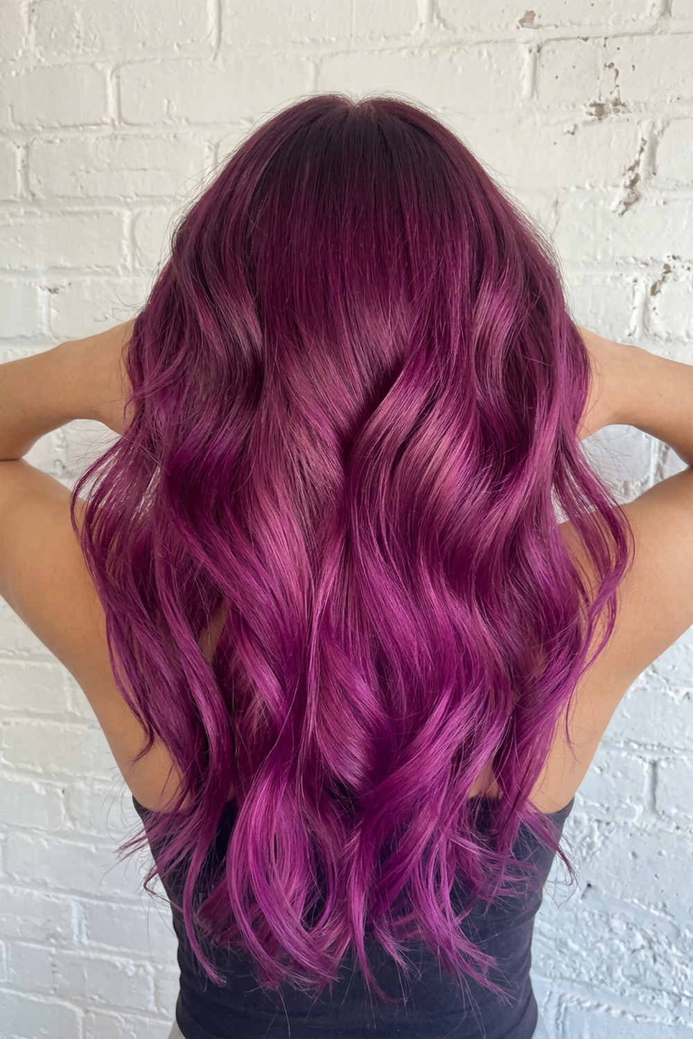 Violet and magenta vivid hair colour melt on long waves by Laila Grigley, Utah colour specialist.